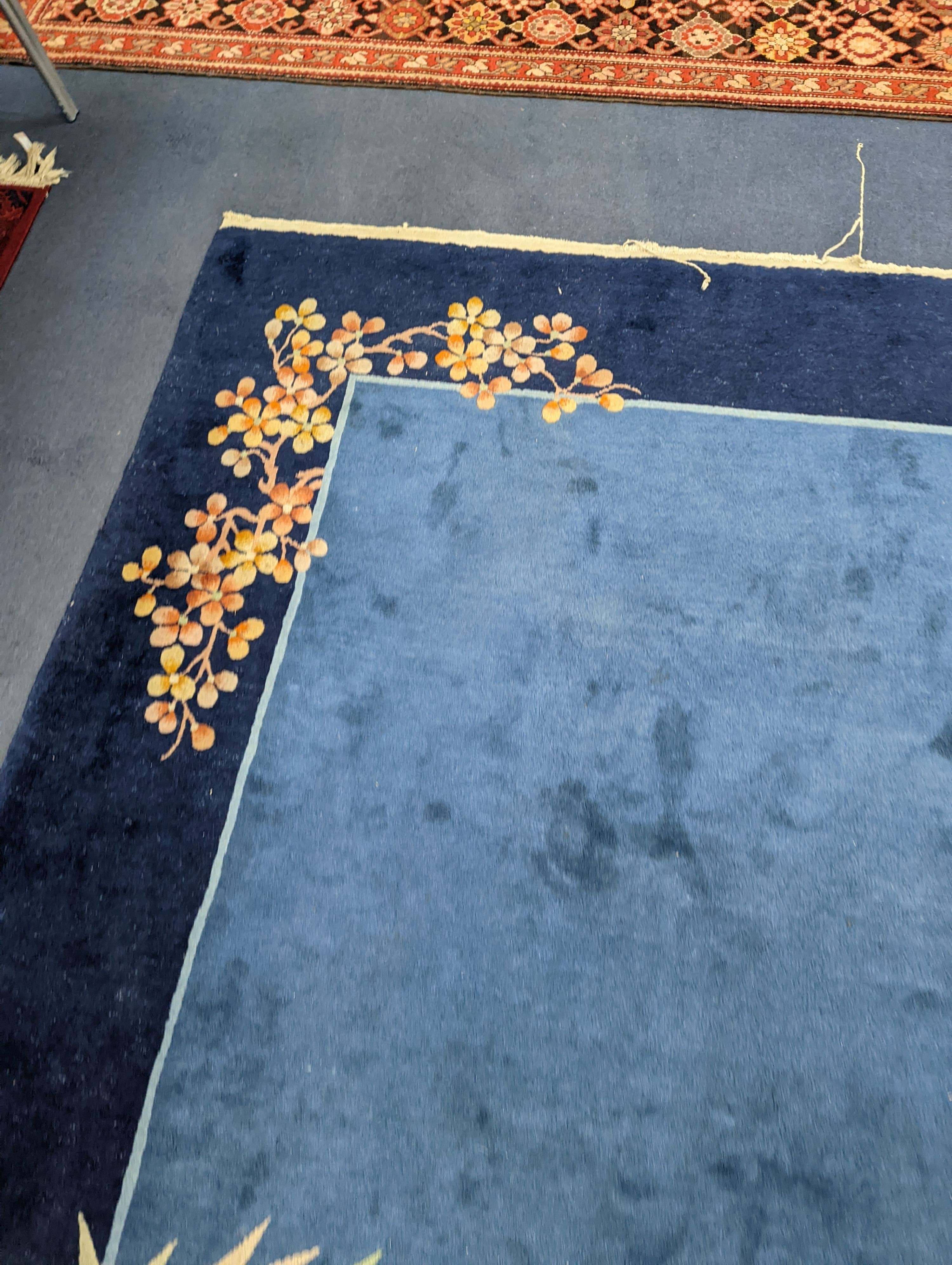 An early 20th century Art Deco Chinese blue ground floral carpet, 400 x 310cm